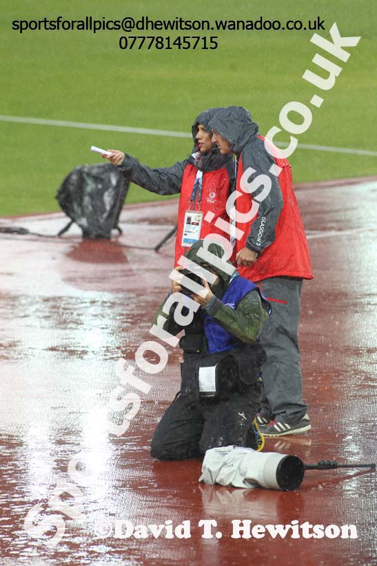 Rain falls on photographer and organisers at the Commonwealth Games, Glasgow. Photo: David T. Hewitson/Sports for All Pics